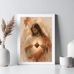 Könnte beinhalten: Ein gerahmter Kunstdruck, der eine Figur mit langem braunem Haar und Bart in einem weißen Gewand zeigt. Die Hände befinden sich in der Nähe eines leuchtenden, roten Herzens, das von einer Dornenkrone umgeben ist, vor einem beigen Hintergrund.