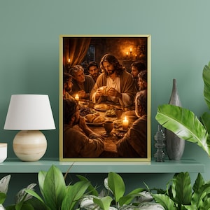 May include: A framed print depicting a religious scene with figures gathered around a table. The central figure, with long hair and a robe, is breaking bread. Warm lighting from candles illuminates the scene, creating a sense of intimacy and reverence.