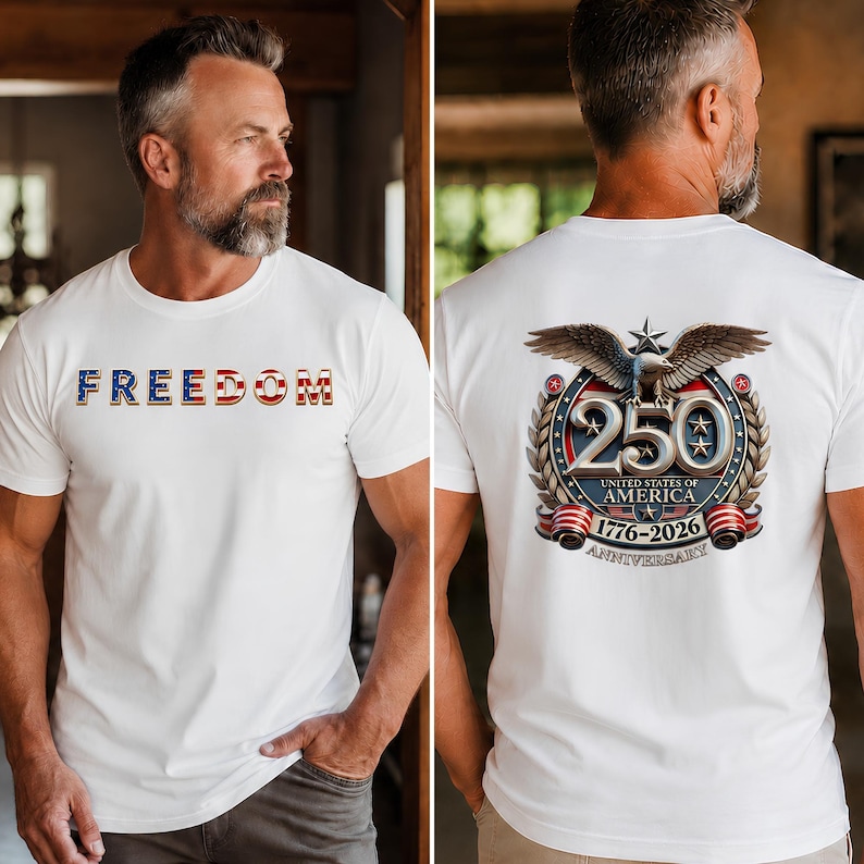 May include: A white t-shirt featuring the word FREEDOM in red, white, and blue lettering on the front. The back displays a graphic of a bald eagle above the number 250, with the text UNITED STATES OF AMERICA 1776-2026 ANNIVERSARY below it.