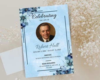 May include: A memorial card with a light blue watercolor background. The card features a portrait of a man, the text "Celebrating the Life of Robert Holl", and service details. Floral accents in shades of blue and navy decorate the borders.