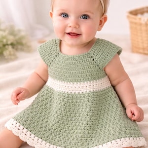 May include: A light green crochet baby dress with a white waist band and trim. The dress has short sleeves and a round neckline. A matching white bow headband is worn by the baby.