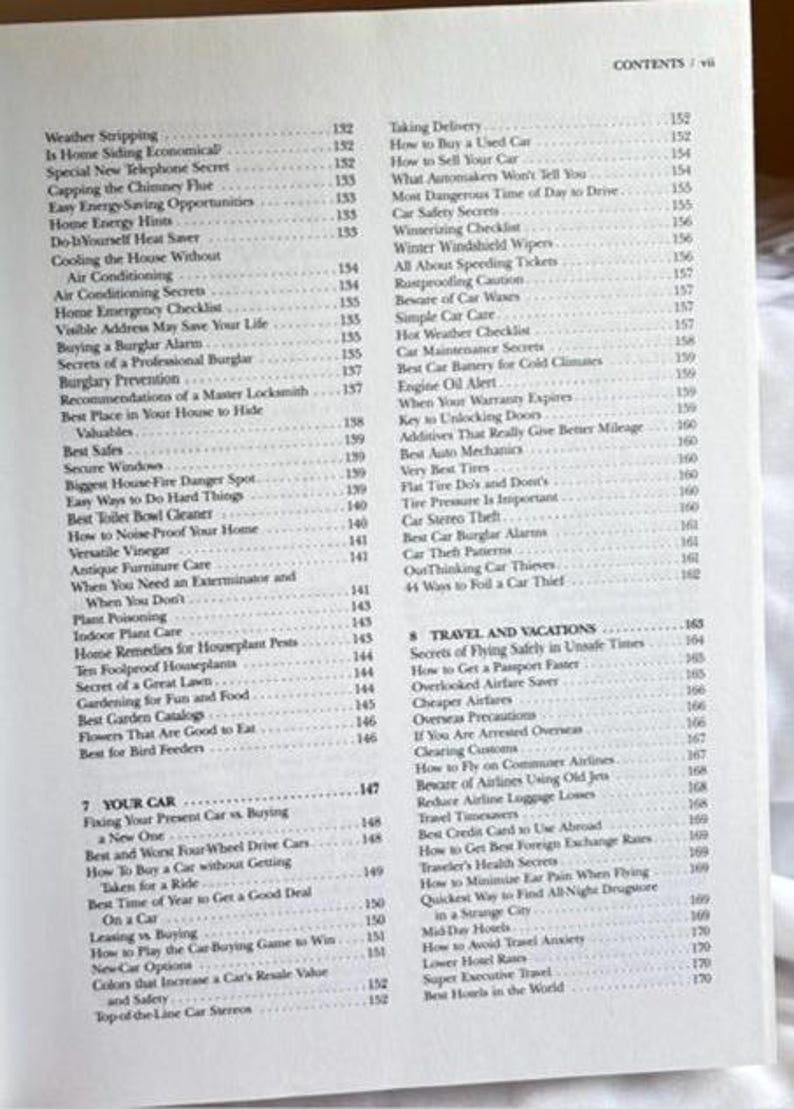 May include: Open book with a table of contents, including topics like car maintenance, home safety, and travel tips. The pages are off-white with black text.