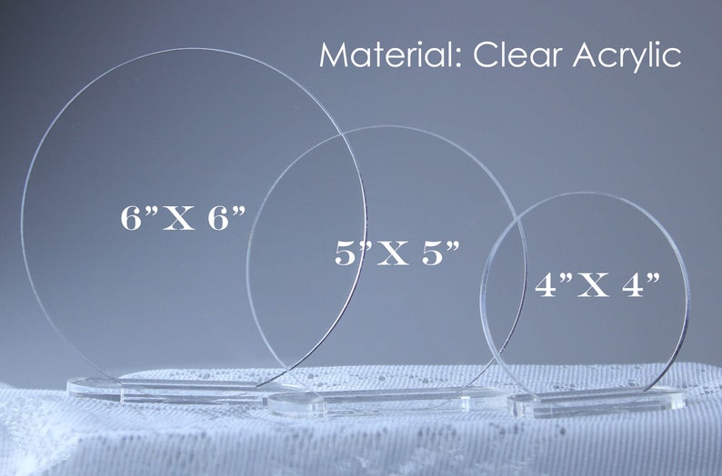 May include: Clear acrylic display stands in three sizes: 6" x 6", 5" x 5", and 4" x 4". Each stand is a clear circle with a rectangular base. The material is clear acrylic.