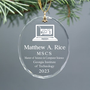 May include: A clear glass ornament with a gold ribbon and a white silhouette of a laptop computer. The text "Matthew A. Rice, MSCS, Master of Science in Computer Science, Georgia Institute of Technology, 2023" is engraved on the ornament.