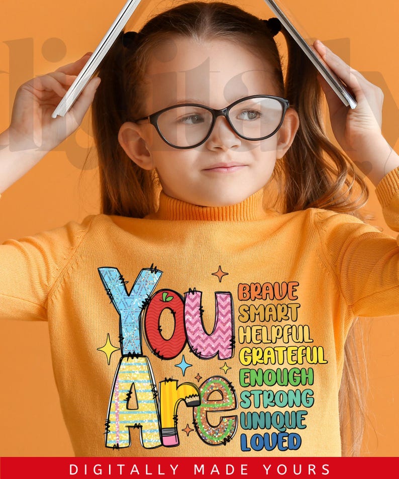 May include: A young person wearing a yellow turtleneck sweater with the words "You Are" in colorful, decorative lettering. The words "Brave, Smart, Helpful, Grateful, Enough, Strong, Unique, Loved" are also displayed. The phrase "DIGITALLY MADE YOURS" is at the bottom.