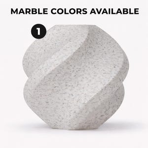 May include: A white marble sculpture with a unique, twisted design. The sculpture has a speckled pattern and is labeled with the number 1. The text "MARBLE COLORS AVAILABLE" is at the top of the image.
