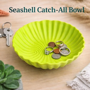 May include: A set of three ceramic mugs with a speckled, matte finish. The mugs are in shades of cream, light gray, and dark gray. Each mug has a simple, minimalist design, perfect for coffee or tea.