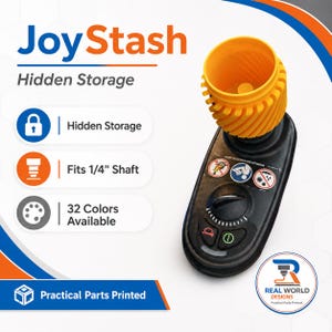May include: A black and orange JoyStash hidden storage device. The device has an orange top and a black base with a dial and buttons. The text "JoyStash Hidden Storage" is at the top. The device fits a 1/4" shaft and is available in 32 colors.
