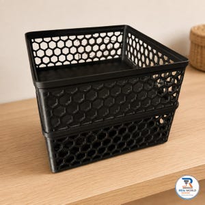 May include: A stack of two black rectangular storage baskets featuring a repeating hexagonal honeycomb pattern on all four sides and a solid base. The baskets have an open top design with a smooth rim and are constructed from a rigid material.