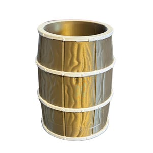 May include: A gold-colored barrel-shaped container with a white rim and bands. The container has a wood grain texture and is designed to resemble a traditional barrel. The bands are white and encircle the barrel.