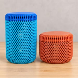 May include: Two cylindrical containers with lids, one taller in bright blue and one shorter in burnt orange. Both feature a distinct lattice-style diamond grid pattern on the exterior walls and a ribbed texture along the edges of the lids.
