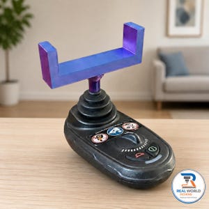 May include: A black plastic controller base with a central joystick and a U-shaped blue and purple gradient phone mount. The base features a circular dial, two buttons, and three circular warning icons with text labels printed on the top surface.