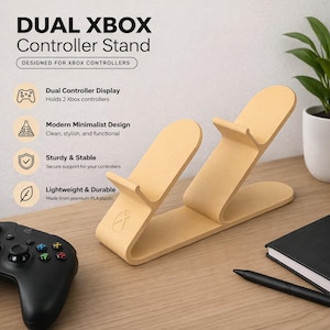 May include: A light yellow Dual Xbox Controller Stand. The stand is designed to hold two Xbox controllers. The text on the stand says "DUAL XBOX Controller Stand" and "DESIGNED FOR XBOX CONTROLLERS". The stand is made of premium PLA plastic.