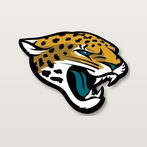 May include: A graphic illustration of a jaguar head in profile, featuring gold fur with black spots, a white muzzle, and a teal tongue. The jaguar has an open mouth showing sharp white teeth, outlined in thick black lines against a light background.