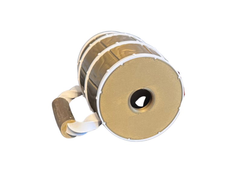 May include: A decorative beer mug with a barrel design. The mug features a light brown barrel body with white and gold accents. The handle is made of a twisted white rope and a brown wooden grip.