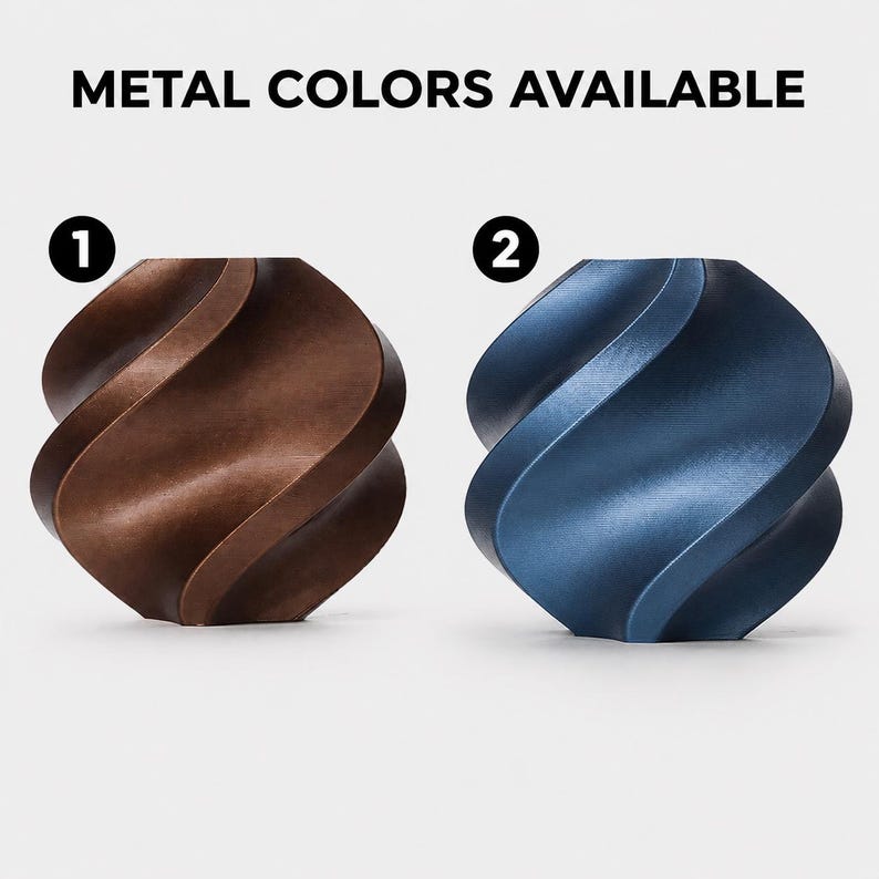 May include: Two decorative metal sculptures with a twisted design. One is bronze-colored, and the other is a deep blue. The text "METAL COLORS AVAILABLE" is at the top, with the numbers 1 and 2 above each sculpture.