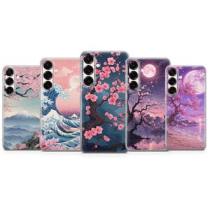 May include: A collection of phone cases featuring Japanese-inspired art. Designs include cherry blossoms, a mountain landscape, a wave, and a full moon over a tree. The cases have a glossy finish and a camera cutout.