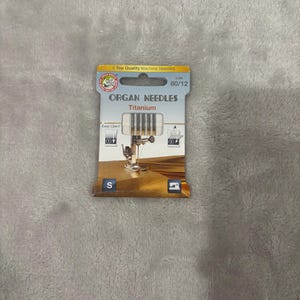 May include: A set of three ceramic mugs with a speckled, matte finish. The mugs are in shades of cream, light gray, and dark gray. Each mug has a simple, minimalist design, perfect for coffee or tea.