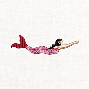 May include: Embroidered image of a mermaid swimming. The mermaid has black hair, a pink flower, and a pink and red tail. The mermaid's body is pink with a geometric pattern. The background is white.