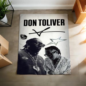 May include: A black and white rug featuring the text "DON TOLIVER" in bold letters. The rug displays two images of a person wearing sunglasses, a lip graphic, and a star graphic.