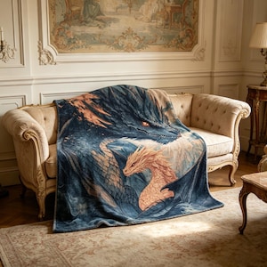 May include: A dragon-themed throw blanket in blue and orange, draped over a beige sofa. The blanket depicts two dragons, a large blue one and a smaller orange one. The blanket is made of a soft material and is suitable for a sofa.