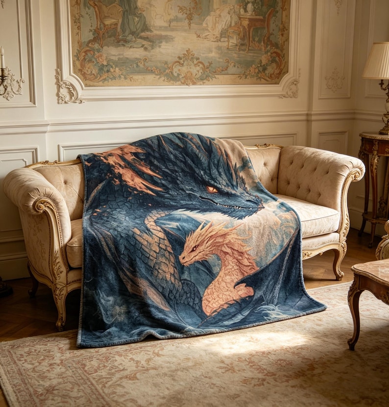 May include: A dragon-themed throw blanket in blue and orange, draped over a beige sofa. The blanket depicts two dragons, a large blue one and a smaller orange one. The blanket is made of a soft material and is suitable for a sofa.