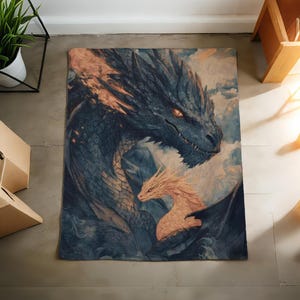 May include: A rectangular rug with a detailed illustration of two dragons. The larger dragon is dark blue with orange accents, and the smaller dragon is a light orange colour. The background has a cloudy, ethereal appearance.