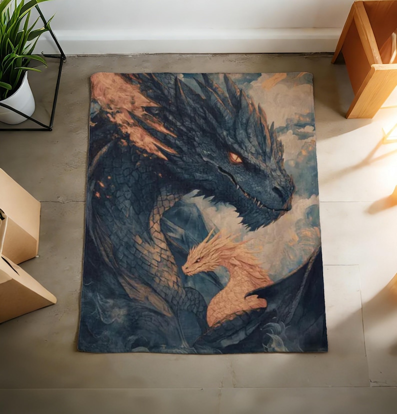 May include: A rectangular rug with a detailed illustration of two dragons. The larger dragon is dark blue with orange accents, and the smaller dragon is a light orange colour. The background has a cloudy, ethereal appearance.