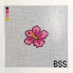 May include: A square needlepoint canvas featuring a central pink hibiscus flower with a yellow stamen. The design includes a color palette guide in the top left corner with four small squares and the letters BSS printed in black in the bottom right.