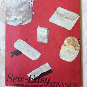 May include: A vintage sewing pattern for making five different eyeglass cases. The pattern is printed on red paper and features a white polka dot design. The pattern is titled "Sew-Easy" and is printed by Advance.
