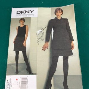 May include: A sewing pattern for a dress with a skirt and a jacket. The pattern is from DKNY, a Vogue American Designer. The pattern number is V1057 and the size is AA (6-8-10-12).