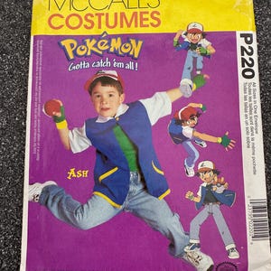 May include: A McCall's Costumes sewing pattern for a Pokémon costume. The package features a child dressed as Ash, with illustrations of the character. The text reads "Pokémon Gotta catch 'em all!" and "Ash".