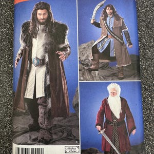 May include: Simplicity pattern 1552A featuring costume designs. The cover shows three figures in fantasy attire, including long coats, belts, and swords. The pattern includes sizes XS-XL.