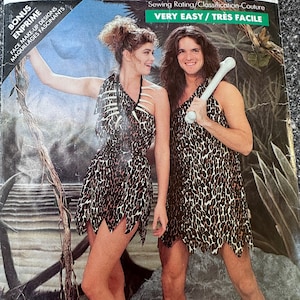 May include: A sewing pattern for a caveman costume. The pattern includes a leopard print dress and a matching loincloth. The pattern is labelled "Very Easy/Tres Facile".
