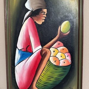 May include: A painting of a person sitting with a basket of fruit. The person is wearing a pink dress, a blue and white apron, and a white head scarf. The basket is green and filled with yellow and orange fruit. The background is a dark green.