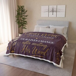 May include: A deep purple blanket featuring gold text: "God's Word doesn't change to meet our lives. Our lives change after meeting His Word." It has a white border and gold leaf details.