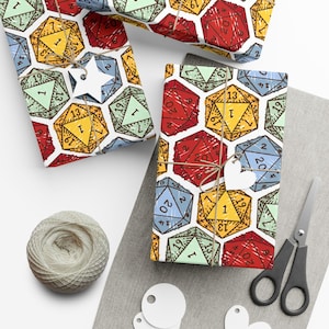 May include: Wrapped presents featuring a vibrant dice pattern in various colours, tied with twine and decorated with star and heart tags. A ball of twine, scissors, and blank tags are also visible, suggesting a gift-giving theme.