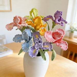 May include: A set of three ceramic mugs with a speckled, matte finish. Each mug features a different color: light blue, cream, and gray. The mugs have a simple, modern design with a rounded shape and a comfortable handle.