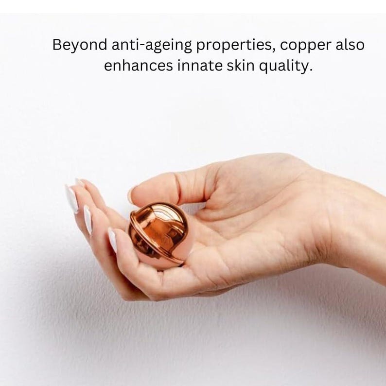 May include: A small, spherical, metallic copper-coloured object with a smooth, reflective surface. The text above the object reads: Beyond anti-ageing properties, copper also enhances innate skin quality.
