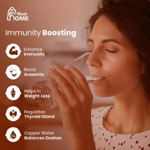 May include: A clear glass of water with text overlay including Must Home, Immunity Boosting, Enhance Immunity, Boost Anaemia, Helps in Weight Loss, Regulates Thyroid Gland, and Copper Water Balances Doshas, alongside five white circular icons.