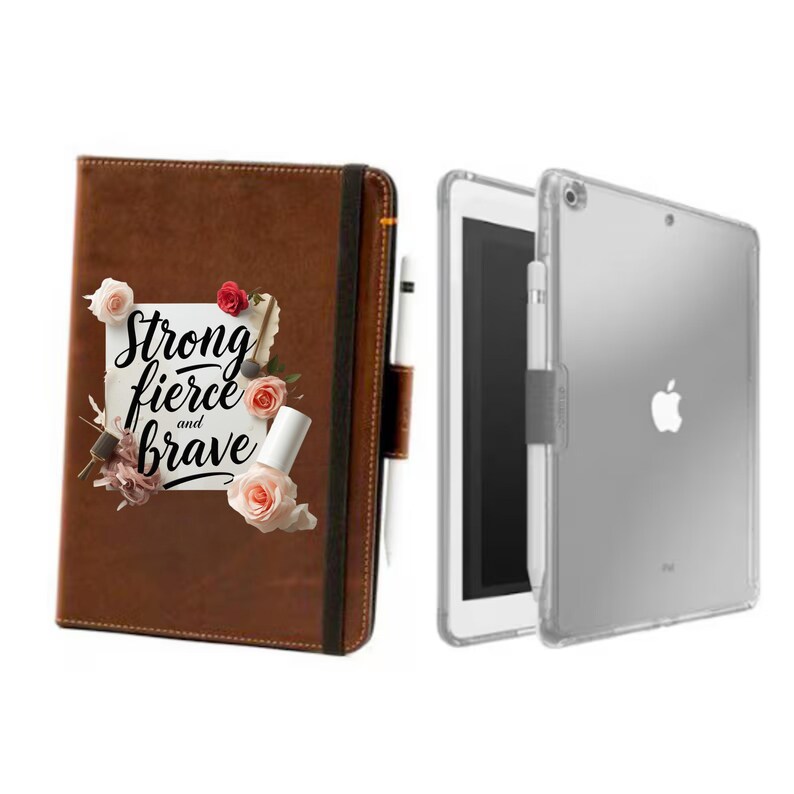 May include: A brown leather journal with the words "Strong, Fierce, and Brave" and floral accents. Next to it is a clear iPad case with an iPad and a white stylus.