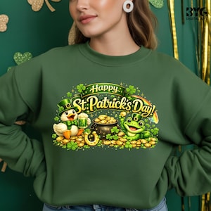 May include: Green sweatshirt with a St. Patrick's Day design. The graphic includes a duck and a frog, both wearing hats and surrounded by gold coins, a pot of gold, and a horseshoe. The text "Happy St. Patrick's Day!" is displayed above the characters.