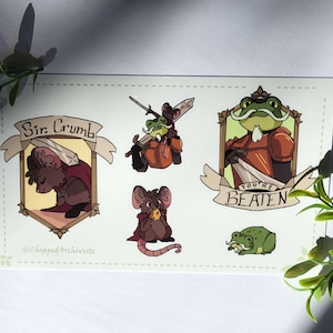 May include: A rectangular sticker sheet featuring cartoon illustrations of anthropomorphic animals. The designs include a mouse knight, a frog knight, and a small frog. The text "Sir Crumb" and "You're Beaten" are included.