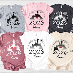 a collection of six t-shirts, each featuring a unique design related to the year 2020. The t-shirts are arranged in a grid pattern, showcasing various color options and styles.