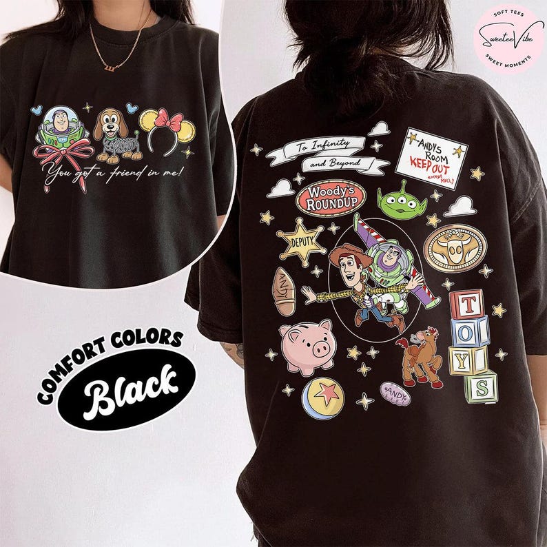 May include: Black comfort colors t-shirt featuring Toy Story characters. The front displays Buzz Lightyear, a dog, and Minnie Mouse ears with the text "You got a friend in me!". The back has various Toy Story graphics and text.