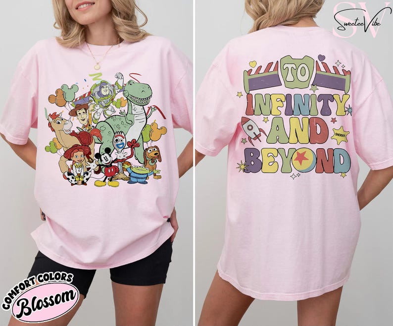 Op de afbeelding: Roze T-shirt met een kleurrijke afbeelding van Toy Story-personages op de voorkant. De achterkant van het shirt heeft de tekst "To Infinity and Beyond". Het shirt is een Comfort Colors Blossom.