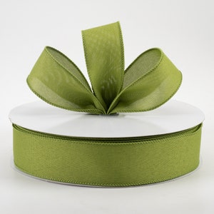May include: A spool of olive green satin ribbon with a wired edge. The ribbon is displayed on a white spool with a bow tied on top.