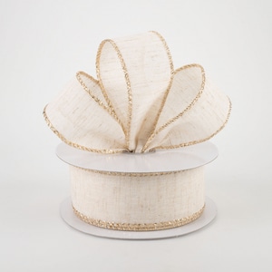 May include: A spool of natural linen ribbon with a gold metallic edge. The ribbon is 2.5 inches wide and is perfect for adding a touch of rustic elegance to your crafts and gifts.