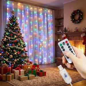 May include: A set of multi-colored LED curtain string lights hanging in front of sheer white curtains, accompanied by a handheld remote control and a USB power connector. The lights feature various color modes for festive illumination.