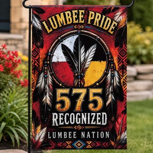 May include: A garden flag with the text "LUMBER PRIDE" in gold lettering. The flag features a central design with feathers, a circle with red, white, and yellow sections, and the numbers "575". The words "RECOGNIZED LUMBER NATION" are also displayed.
